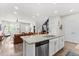 Bright open concept kitchen featuring a center island with granite countertops and stainless steel appliances at 4774 Kittredge St, Denver, CO 80239