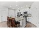 Modern kitchen features granite countertops, stainless steel appliances, and an island with barstool seating at 4774 Kittredge St, Denver, CO 80239