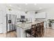 Open kitchen with stainless steel appliances, granite counters, and a spacious island with seating at 4774 Kittredge St, Denver, CO 80239