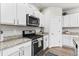 Modern kitchen with granite countertops, stainless steel appliances, and custom cabinetry for an elegant design at 4774 Kittredge St, Denver, CO 80239