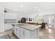 Expansive island with granite counters and barstool seating anchors this open-concept kitchen and living space at 4774 Kittredge St, Denver, CO 80239