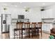 Bright kitchen boasts white cabinets, stainless appliances, granite counters, and bar stool seating at the island at 4774 Kittredge St, Denver, CO 80239