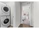 Convenient laundry room features a modern stackable washer and dryer near bedroom at 4774 Kittredge St, Denver, CO 80239