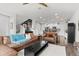 Spacious living room with large windows, modern furnishings, and easy access to kitchen and staircase at 4774 Kittredge St, Denver, CO 80239