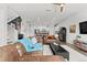 Open-concept living room seamlessly connects to the modern kitchen, creating a cohesive and inviting living space at 4774 Kittredge St, Denver, CO 80239