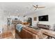Open concept living area with modern furnishings, wood floors, and a seamless kitchen view at 4774 Kittredge St, Denver, CO 80239