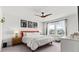 Charming main bedroom with decorative fan, large windows, and a decorative headboard at 4774 Kittredge St, Denver, CO 80239
