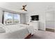 Spacious main bedroom with a large window for natural light and modern ceiling fan at 4774 Kittredge St, Denver, CO 80239