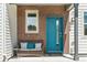 Cozy front porch featuring a brick accent wall and seating area at 4774 Kittredge St, Denver, CO 80239