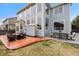 Backyard showcasing a patio with outdoor seating and a well-maintained lawn at 13078 Monaco Way, Thornton, CO 80602