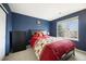 Cozy bedroom featuring navy walls, a window with natural light, and a comfortable bed at 13078 Monaco Way, Thornton, CO 80602