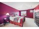 Primary bedroom featuring vibrant purple walls, two windows with natural light, and a comfortable bed at 13078 Monaco Way, Thornton, CO 80602
