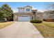 Charming two-story home with brick and light blue accents, a well-manicured lawn, and an attached two-car garage at 13078 Monaco Way, Thornton, CO 80602