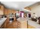 Kitchen open to the living area, with stainless steel appliances and a large island at 13078 Monaco Way, Thornton, CO 80602