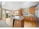 Bright kitchen featuring stainless steel appliances, hardwood floors, and an eat-in kitchen space at 13078 Monaco Way, Thornton, CO 80602
