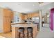 Kitchen with an island, stainless steel appliances, and breakfast bar seating at 13078 Monaco Way, Thornton, CO 80602