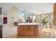 Kitchen with island is open to bright living room with fireplace and large windows at 13078 Monaco Way, Thornton, CO 80602