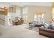 Spacious living area with soaring ceilings, comfortable furniture, and natural light from large windows at 13078 Monaco Way, Thornton, CO 80602