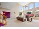 Bright living room with vaulted ceilings, large windows, and a cozy fireplace at 13078 Monaco Way, Thornton, CO 80602