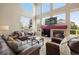 Cozy living room features large windows, a fireplace, and a comfortable seating area for relaxation and entertainment at 13078 Monaco Way, Thornton, CO 80602