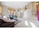 Inviting living room features high ceilings, a cozy seating area, and ample natural light from large windows at 13078 Monaco Way, Thornton, CO 80602