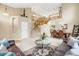 Open-concept living room with a grand staircase, comfortable seating, and elegant decor at 13078 Monaco Way, Thornton, CO 80602