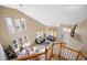 Open-concept living space featuring a living room, dining area, and ample natural light from large windows at 13078 Monaco Way, Thornton, CO 80602