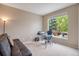 Home office with a large window, modern desk setup, and comfortable futon at 13078 Monaco Way, Thornton, CO 80602