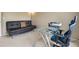Comfortable room with a black futon, a glass desk and an ergonomic chair at 13078 Monaco Way, Thornton, CO 80602