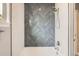 Modern bathroom featuring gray herringbone tile accent wall and bright white tile at 4586 Carefree Trl, Parker, CO 80134