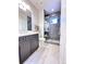 Bathroom with floating vanity and tiled shower with glass doors at 4586 Carefree Trl, Parker, CO 80134