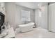 Bright bathroom featuring a freestanding tub, marble floors, and a modern shower at 4586 Carefree Trl, Parker, CO 80134