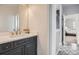 Bathroom vanity with a dark cabinet, white countertop, with access to bathroom and bedroom at 4586 Carefree Trl, Parker, CO 80134