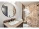 Bathroom featuring a granite vanity, tile shower, and bronze fixtures at 4586 Carefree Trl, Parker, CO 80134