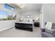 Airy bedroom boasts high ceilings, large windows, and a cozy reading chair at 4586 Carefree Trl, Parker, CO 80134