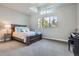 Bedroom features a bed set, large window, and high ceilings at 4586 Carefree Trl, Parker, CO 80134