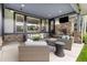 Spacious covered patio with stone fireplace and stylish wicker seating at 4586 Carefree Trl, Parker, CO 80134