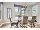 Bright dining area featuring a modern table set and natural light from large windows at 4586 Carefree Trl, Parker, CO 80134