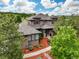 A gorgeous exterior featuring beautiful stone and manicured landscaping under a cloudy, bright sky at 4586 Carefree Trl, Parker, CO 80134