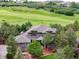 Beautiful home featuring a well-maintained lawn, mature trees, and stunning golf course views at 4586 Carefree Trl, Parker, CO 80134