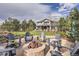 Landscaped backyard with a stone fire pit surrounded by Adirondack chairs for outdoor gatherings at 4586 Carefree Trl, Parker, CO 80134