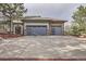 Three car garage with modern doors and spacious driveway at 4586 Carefree Trl, Parker, CO 80134