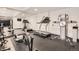 Bright home gym featuring multiple machines, mirrored wall, and rubber floor at 4586 Carefree Trl, Parker, CO 80134