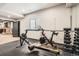 Home gym featuring modern exercise equipment, rubber flooring, and natural light at 4586 Carefree Trl, Parker, CO 80134