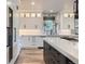 Well-lit kitchen with stylish white cabinetry, marble countertops, and sleek black hardware at 4586 Carefree Trl, Parker, CO 80134