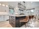 Modern kitchen featuring a large island with seating and stylish pendant lighting at 4586 Carefree Trl, Parker, CO 80134