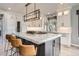 Contemporary kitchen with a large island, marble countertops, and stainless steel appliances at 4586 Carefree Trl, Parker, CO 80134