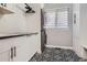 Stylish laundry room with patterned tile floor and modern washer and dryer at 4586 Carefree Trl, Parker, CO 80134
