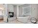 Luxurious main bathroom with a freestanding tub and stone fireplace at 4586 Carefree Trl, Parker, CO 80134