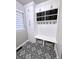 Well-organized mud room with built-in storage and patterned tile floor at 4586 Carefree Trl, Parker, CO 80134